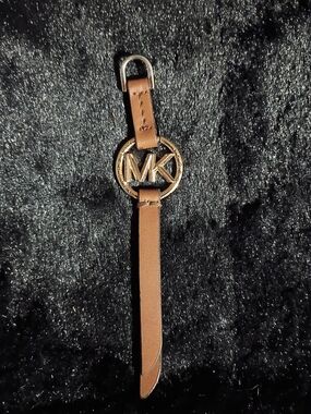 Michael Kors handbag charm gold-toned MK logo medallion on brown leather Strap